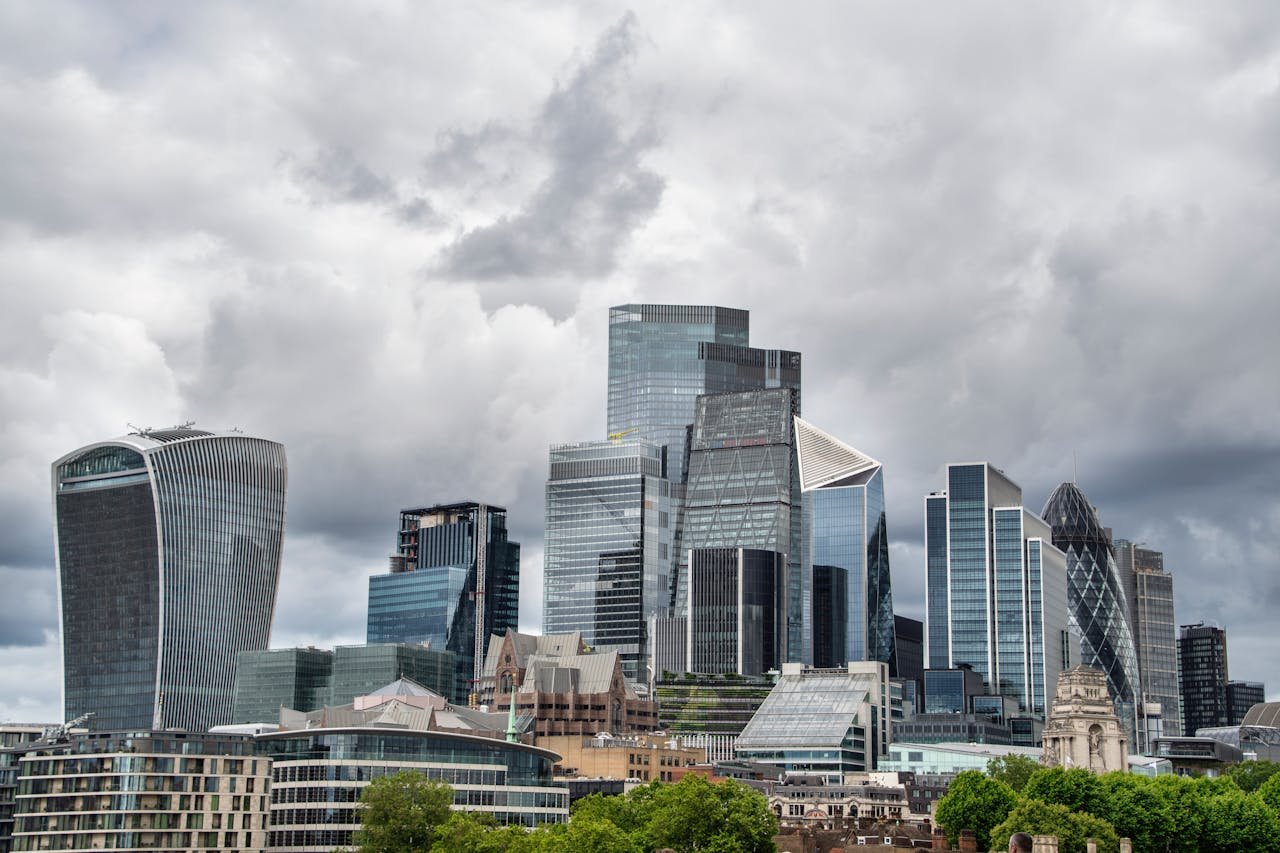 The city of london skyline is shown under a cloudy sky